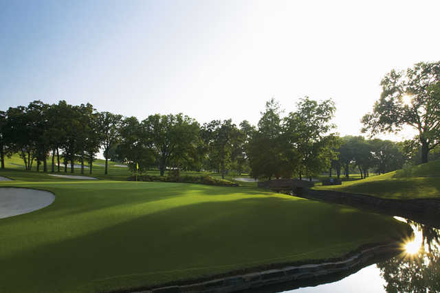 A view of a hole surrounded by water at Southern Hills Country Club
