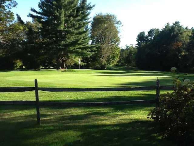 A view over a fence of a green at Angus Lea Golf & Tennis Club