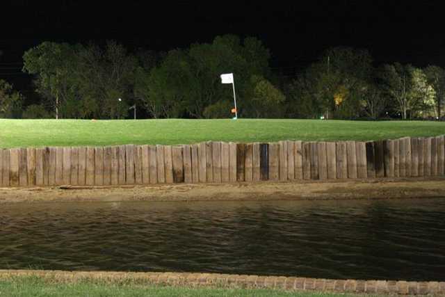 A view of a green surrounded by water at White Barn Estates