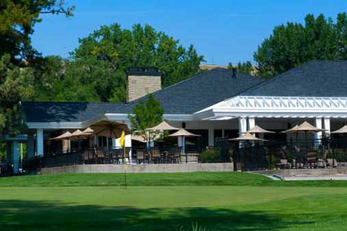 A view of a hole and the clubhouse in background at Hilands Golf Club