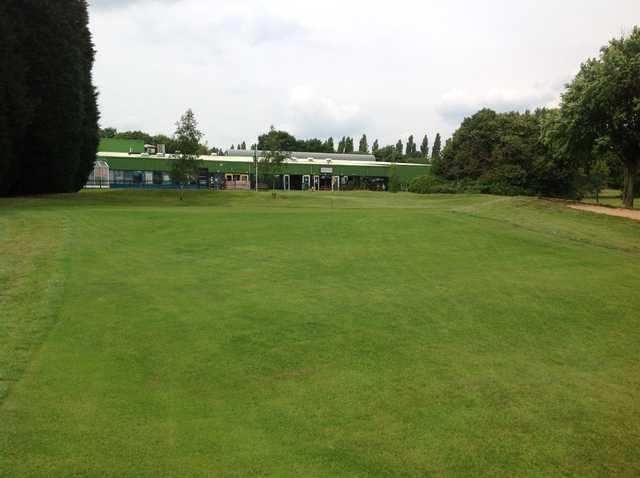 The 18th green and clubhouse at Cocks Moors Woods Golf Club