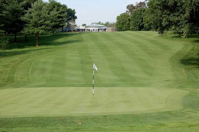 A view of a green and the clubhouse at Rolling Hills Country Club