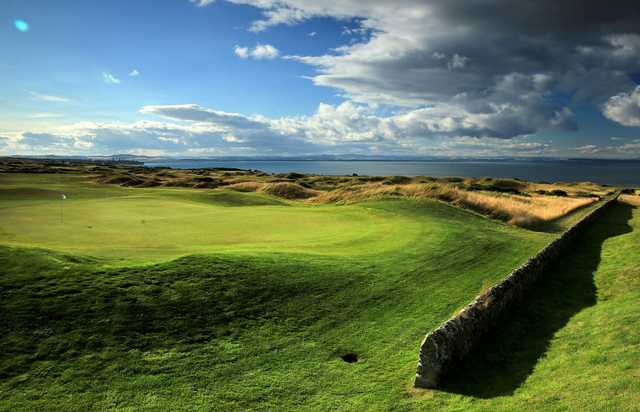 A view of a green and water in the distance at Fairmont St. Andrews.