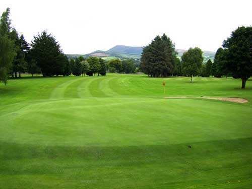 A view of a green with a sand trap on the right side at Mitchelstown Golf Club