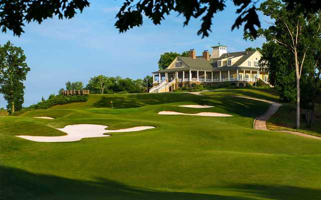 A view of the 18th hole protected by bunkers and the clubhouse in the distance at Schoolmaster Course from Shoals Golf Club