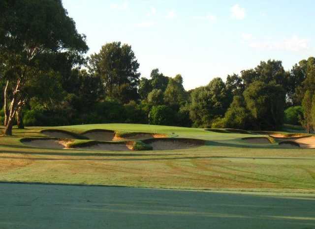 A view of a green protected by bunkers at Grange Golf Club
