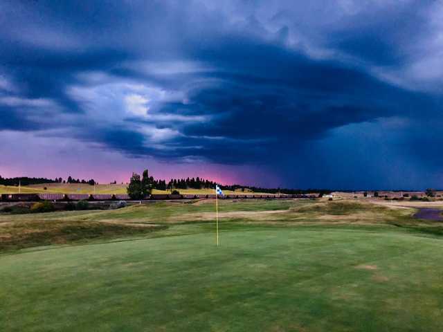A cloudy day view of a hole at Ponderosa Butte Golf Course.