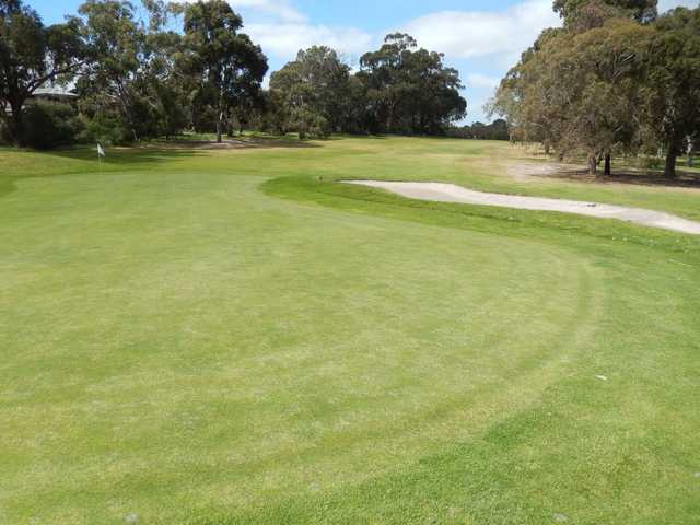 A sunny day view of a hole at Spring Park Golf Course.