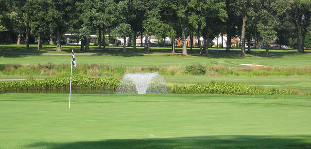 A view of a green with a water fountain in background at Innsbrook Country Club