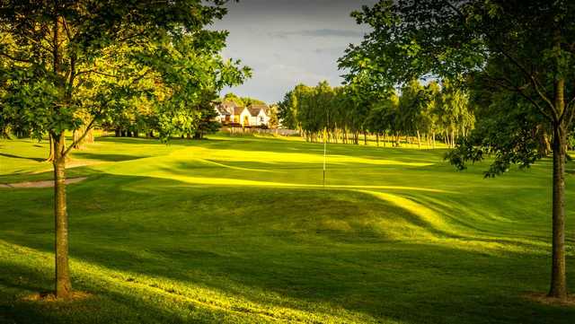 A sunny day view of a green at Bothwell Castle Golf Club.