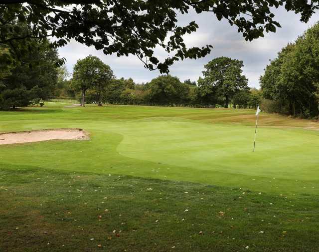 The 8th green and bunker at Helsby Golf Club
