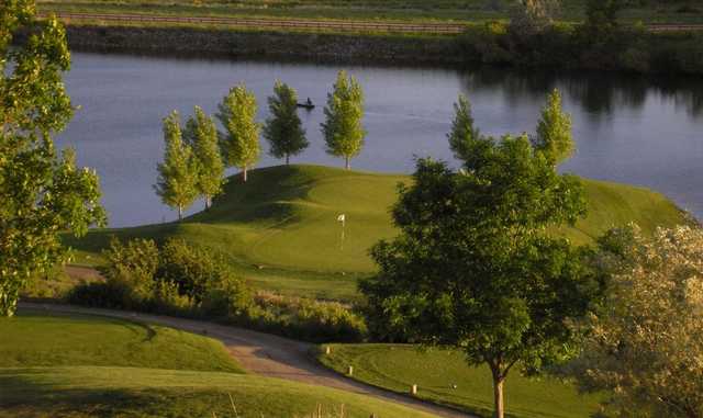 A view of the 16th hole surrounded by water at Bear Creek Golf Club