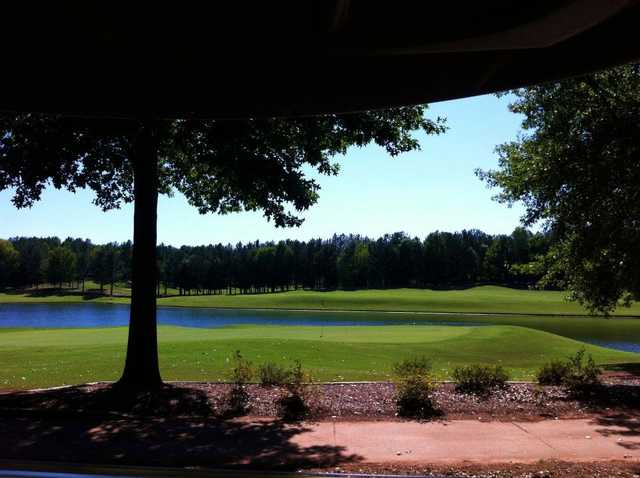A view of a green with water in background at Ol' Colony Golf Course.