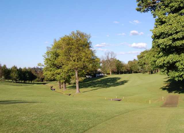 The sloping fairways and water hazard leading to the 4th at Broomieknowe