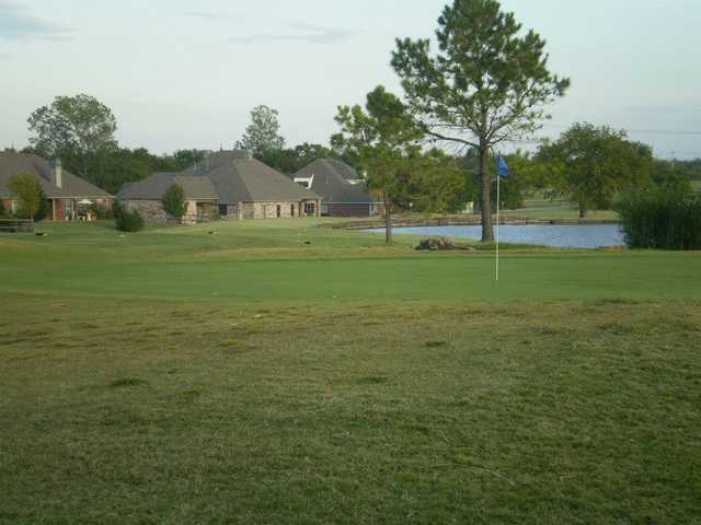 A view of a green with water in background at White Hawk Golf Club