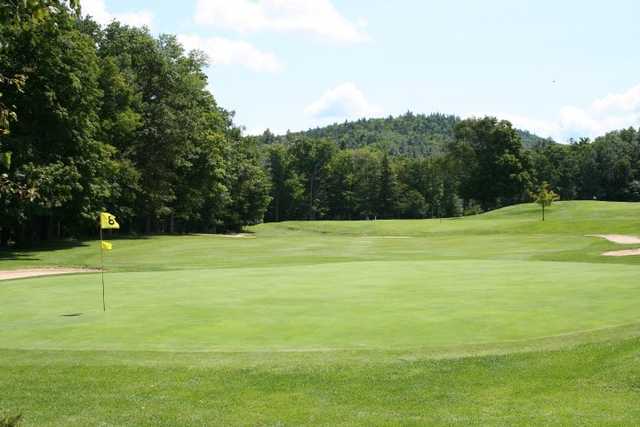 A view of a green protected by sand traps at Wentworth Golf Club