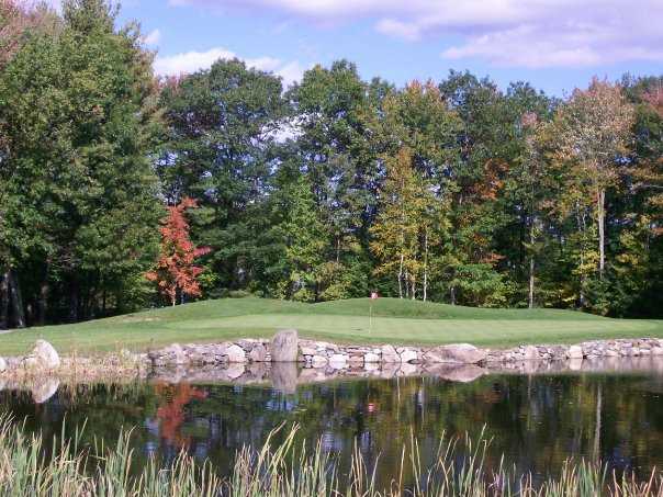 A view of a green with water coming into play at Windham Country Club