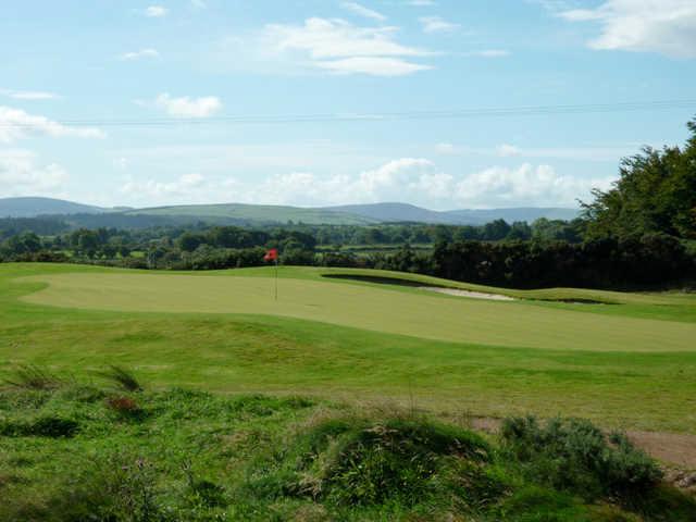 A view of a green protected by a bunker at Ballinastoe Golf Club.
