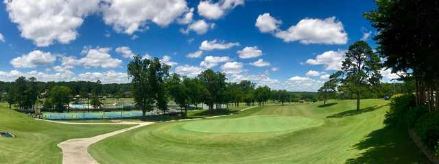 A view of a green and the tennis courts and the swimming pool in background at Gadsden Country Club.