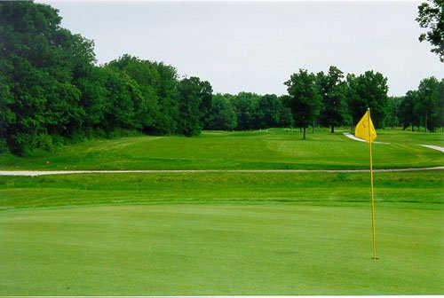 A view of a hole with a cart path in background at Oaktree Golf Course