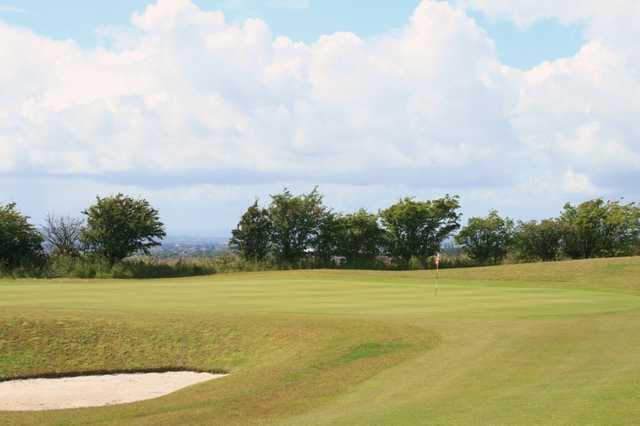 A view of a green protected by a bunker at Torrance Park Golf Course