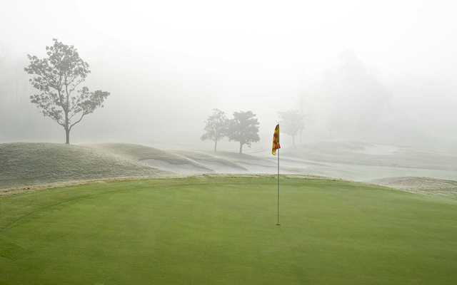A view of green #10 surrounded by fog at Falls Course from Magnolia Grove Golf Club