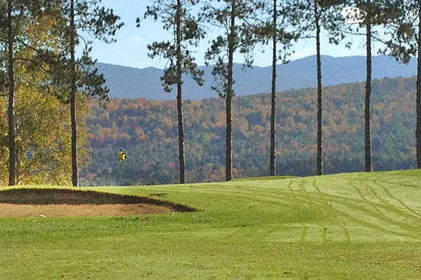 A view of a green protected by bunkers at Proctor-Pittsford Country Club