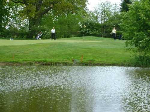 A view over the water of green at Billingbear Park Golf Club