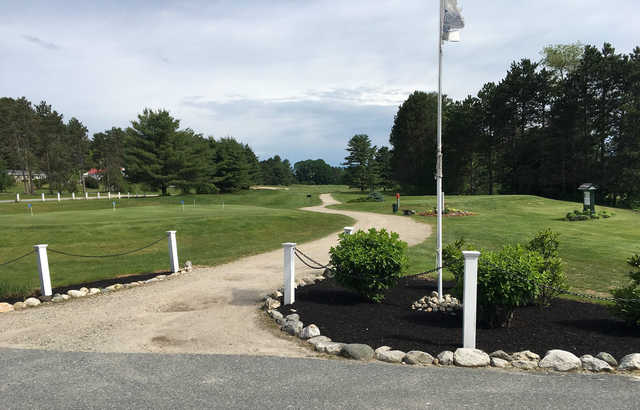 A view of a tee and the practice putting green at Newport Golf Club.