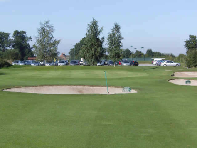A view of hole #18 surrounded by bunkers at Broughton Heath Golf Course