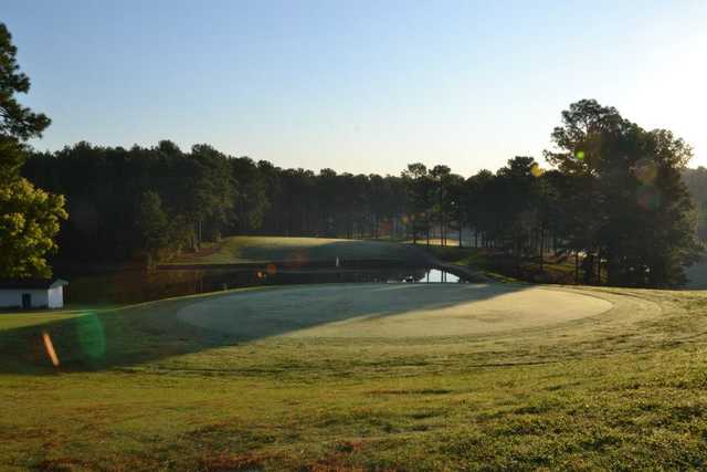 A sunny view of green with water coming into play at Frank House Golf Course