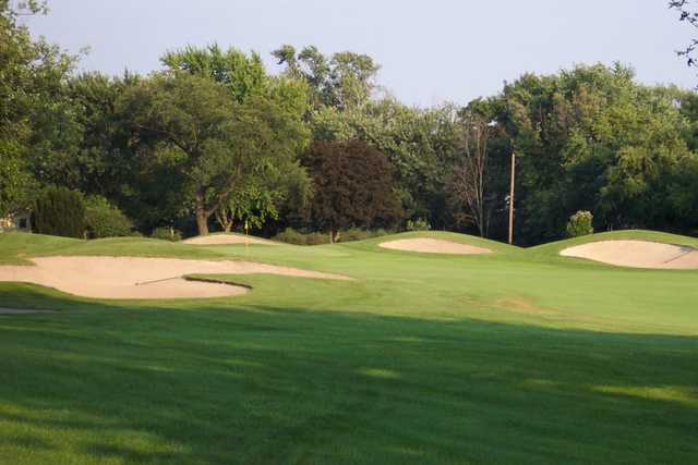 A view of a green defended by tricky sand traps at Youche Country Club