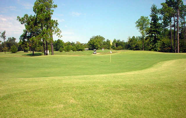 A sunny day view of a green at Idabel Country Club.