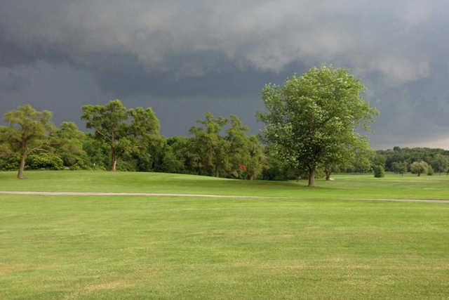 A cloudy day view of a hole at Oak Knoll Golf Club