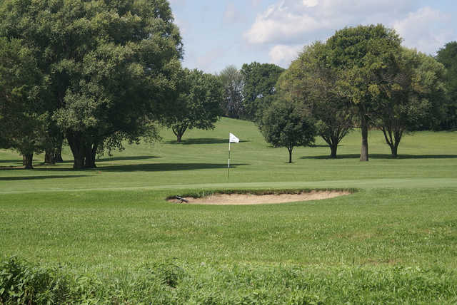 A view of a green protected by a bunker at Valley View Golf Course