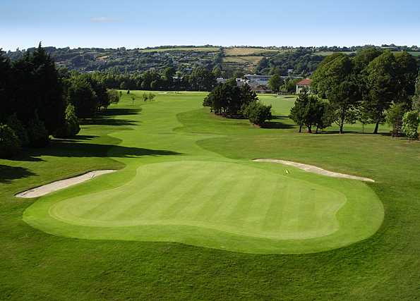 A view of a green protected by sand traps at Cork Golf Club