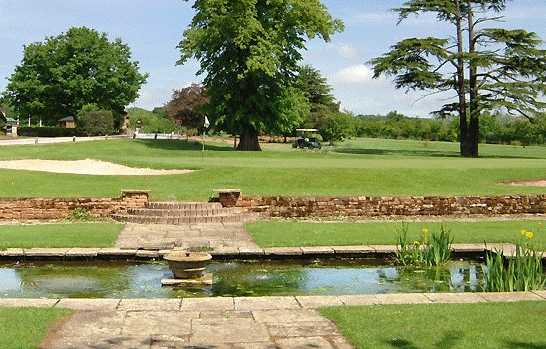 A view of a green guarded by bunkers at Ruddington Grange Golf Club