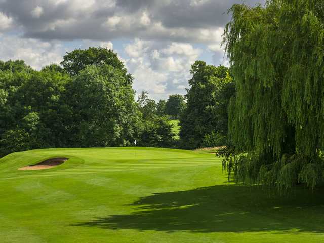A view of a green protected by a bunker at Tewkesbury Park Hotel Golf Course
