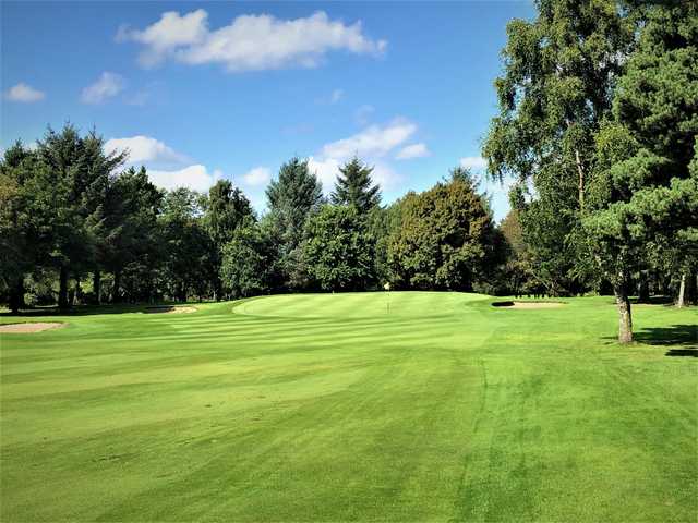 A view of a green flanked by bunkers at Thornton Golf Club.