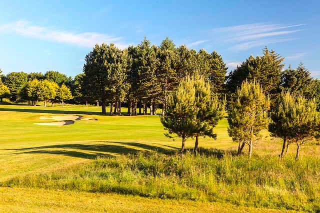 A sunny day view of a hole at Woodbrook Golf Club.