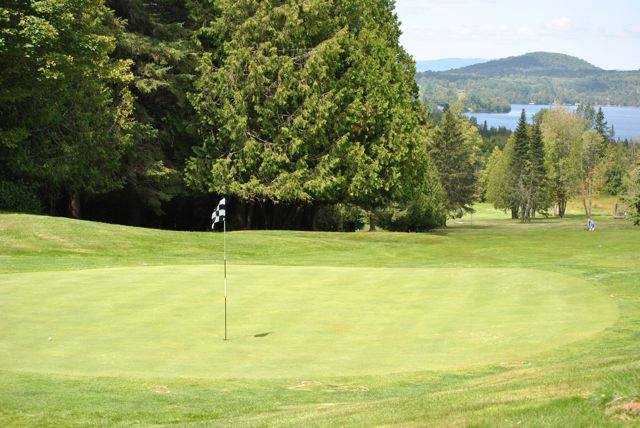 A view of green #8 and the Caspian Lake lake in the distance at Mountain View Country Club