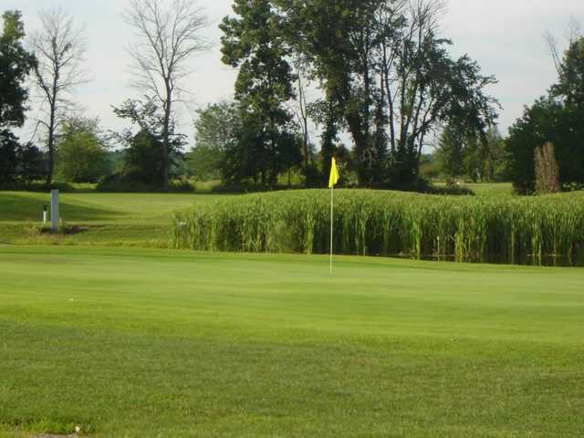 A view of a green protected by a pond at Clear Creek Golf Course