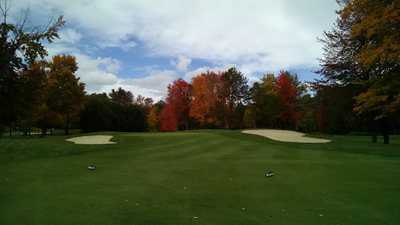 A view of a green flanked by bunkers at Concord Country Club