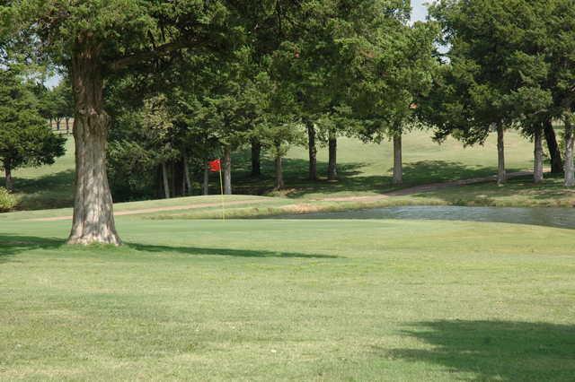 A view of a green with water coming into play at Cedar Valley Golf Club