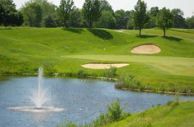 A view of a green protected by bunkers at Cobblestone Golf Course