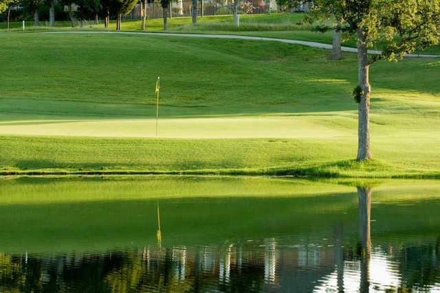A view over the water of a hole at River Oaks Golf Club