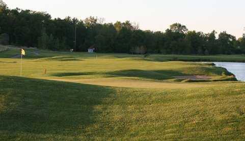A sunny view of green with water coming into play at Eagle Glen Golf Course