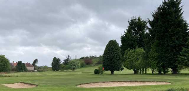View of a bunkered green at Leslie Golf Club.